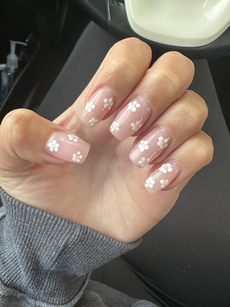 Manicured nails displayed in a salon setting.